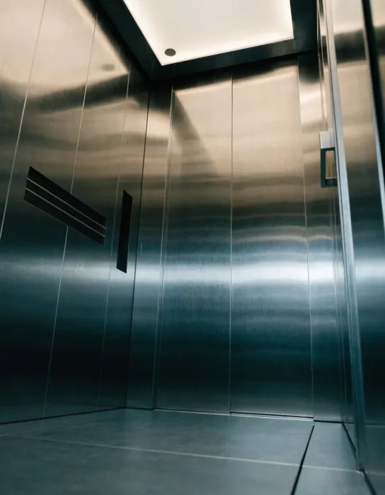 Passenger elevator cabin with hairline stainless steel finish