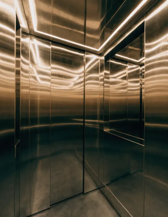 Passenger elevator cabin with titanium-gold mirror stainless finish